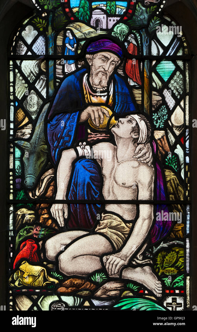 Good Samaritan stained glass by Albert Lemmon in St. Peter`s Church, Bengeworth, Evesham, Worcestershire, England, UK Stock Photo